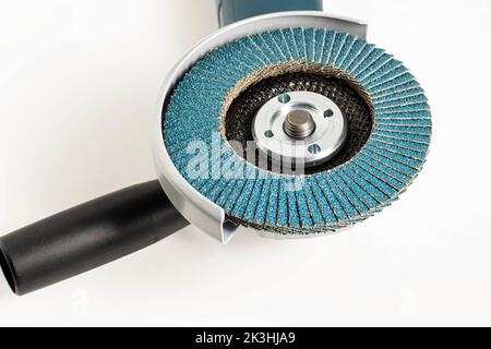 Modern professional angle grinder with a flap wheel on a white background. Power tool for work. Sanding wood and metal. Close-up Stock Photo