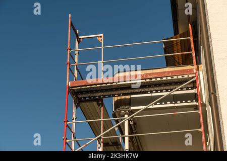 Scaffolding on a house balcony with guttering Stock Photo