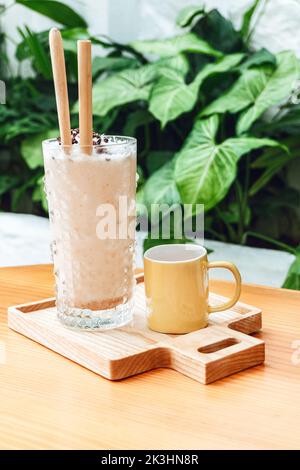 Iced coffee and black coffee in a mug, morning in a cafe on the light background. Stock Photo