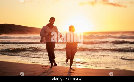 Silhouette couple, beach sunset and running outdoors on summer vacation, honeymoon travel and tropical vacation in Maldives. Shadow man, love woman Stock Photo