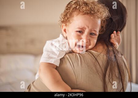 Mother and crying baby in a bedroom with portrait of sad son looking upset at nap time. Children, love and insomnia with baby boy comfort by loving Stock Photo