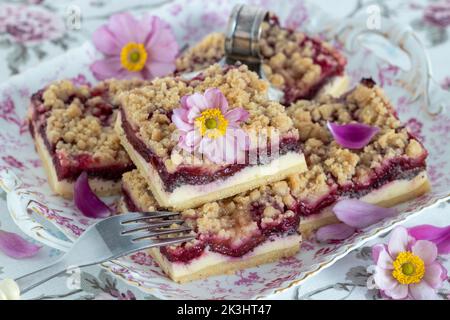 pieces of plum poppy seed cheesecake with cinnamon crumble on plate Stock Photo
