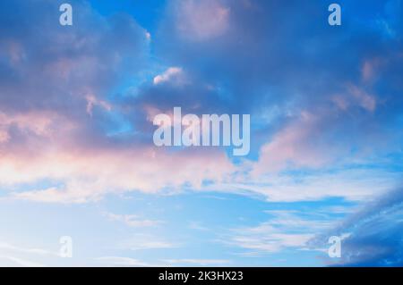 Sky background, scenic dramatic sky in pastel tones, vast panoramic evening sky with soft sunlit pink clouds Stock Photo