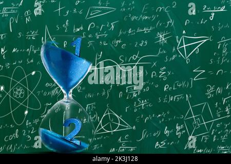 hourglass on the background of formulas Stock Photo