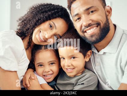 Portrait, selfie and happy family bonding, sharing a caring moment and posing for a picture while hug on a sofa at home. Adoption, care and foster Stock Photo