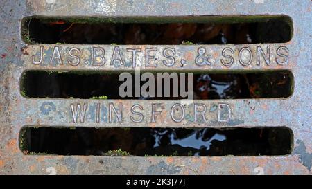 Cast Iron grid, embossed with JAS Bates & Sons, Winsford, Cheshire, England, UK, CW7 1AD - Essential for efficient urban road drainage for downpours Stock Photo