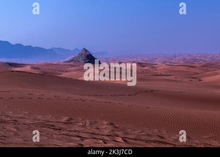 Maleha desert. Maleha is a big dunes in Sharjah, UAE. Fossil rock or pink rock is a hard rock structure right in between sand dunes, an natural wonder Stock Photo