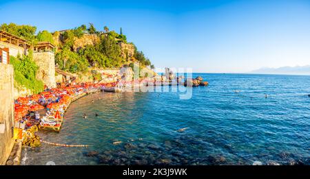 Antalya, Turkey - September 10, 2022: People on the beach near port in old town of Antalya, Turkey Stock Photo