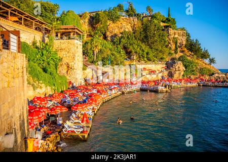 Antalya, Turkey - September 10, 2022: People on the beach near port in old town of Antalya, Turkey Stock Photo