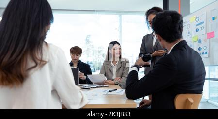 diverse business team people discuss financial result review paperwork share ideas brainstorm collaborate work in teamwork at group briefing table. Stock Photo