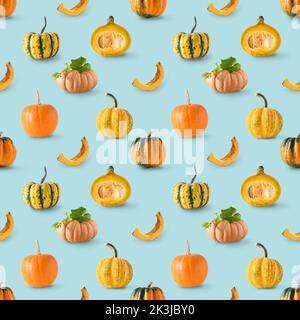 Seamless pattern of different pumpkins on blue background. Autumn harvest for Thanksgiving day. Stock Photo