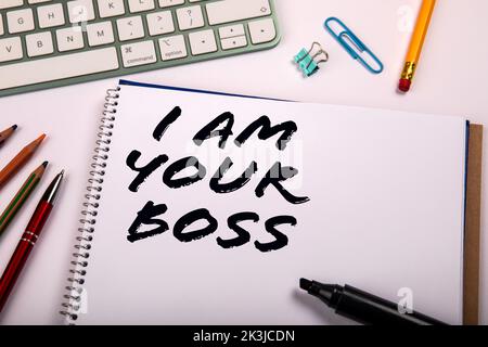 I Am Your Boss. Office supplies on a white table. Stock Photo