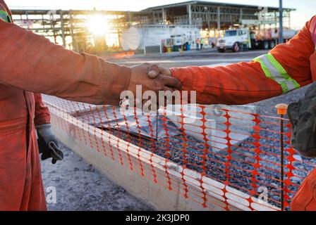 A closeup of two engineers shaking hands Stock Photo