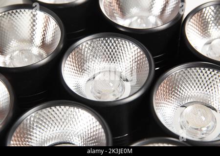 Spot overhead black lamps on a stretch ceiling on a white background. Lamps in the shape of a tube Stock Photo