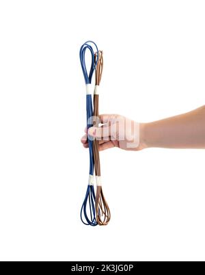 Wires with brown and blue insulation in a person's hand on a white background, isolate. Stock Photo