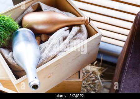 Two empty wine bottles lying in wooden box. Wine box filled with bottle corks and sackcloth Stock Photo
