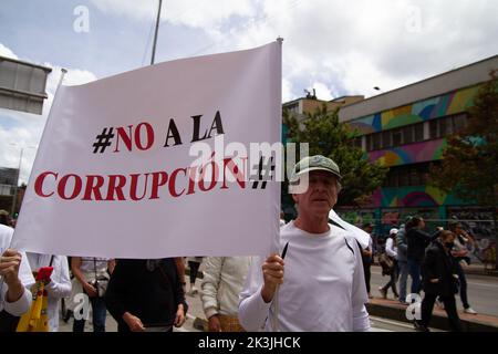 A demonstrator carries a sign that reads 'No to corruption' during the first antigovernment protest against left-wing president Gustavo Petro and his Stock Photo