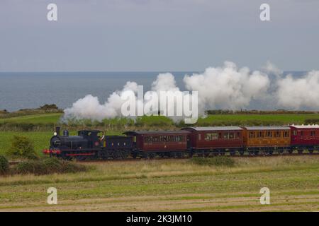 Steam locomotive GER Y14 0-6-0 – 564 pulling a vintage train with the Wisbech & Upwell Tramcar No 7, on the North Norfolk Railway Stock Photo