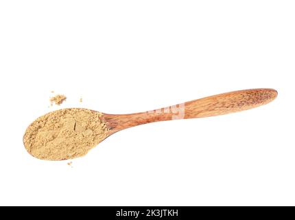 Powder of ground ginger on a wooden spoon over a white background. Top view, copy space. Stock Photo