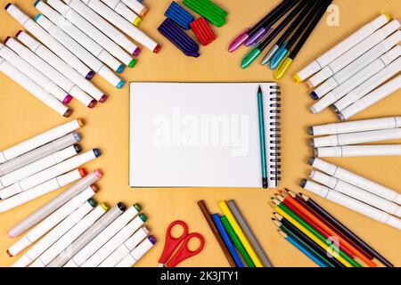 White notebook with a place for inscription on a yellow background. Many different stationery Stock Photo