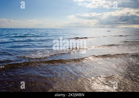 Bad weather incoming above the sea at Southend near the Mull of Kintyre Scotland with blue sky grey clouds and waves Stock Photo