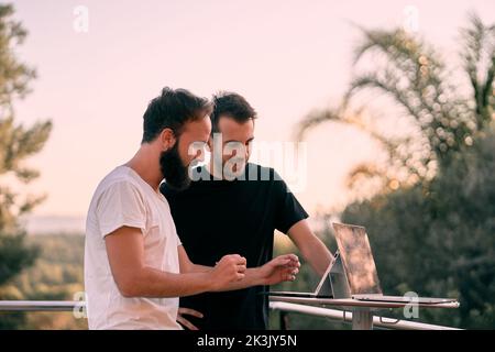 Two young entrepreneur men having a business meeting while working online with their tablets Stock Photo