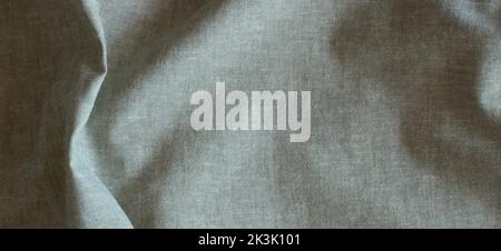 Abstract crumpled linen fabric texture background. Natural pale green color dyed linen organic eco textiles canvas background. Top view Stock Photo