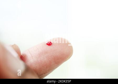 blood on finger, man's hand measuring blood sugar level  Stock Photo