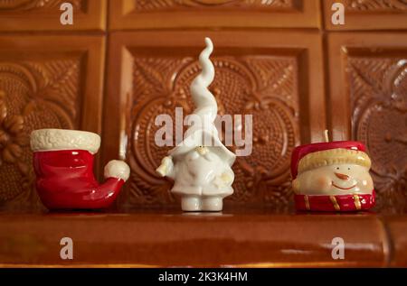 Close up of white Ceramic Santa, Chistmas candle and snowman. Stock Photo