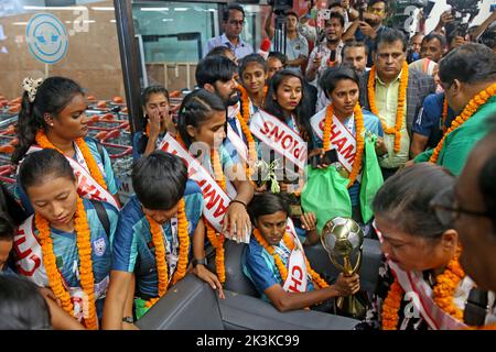 Bangladesh Women Football Team Captain Sabina Khatun (C) along Bangladesh Football Federation officials and teammates hold the trophy as they arrived Stock Photo