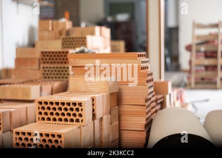 Stacks of bricks in apartment during repair works Stock Photo