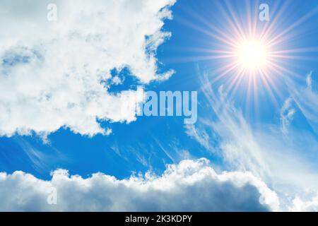 Sun shines brightly in the blue sky through the clouds Stock Photo