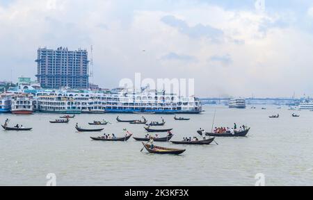 Beautiful landscape of Sadarghat river port on Buriganga river in Dhaka. Ferry boats on the river with a cloudy sky background. Stock Photo