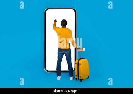 Back view of black man tourist using big cell phone Stock Photo