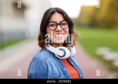 Portrait Of Young Arab Student Female In Stylish Eyeglasses Standing Outdoors Stock Photo