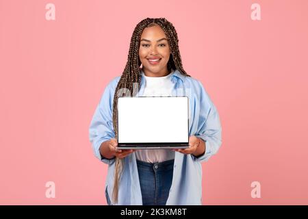 African American Lady Showing Laptop Empty Screen Over Pink Background Stock Photo