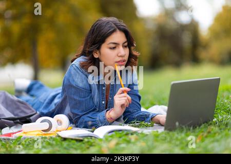 Learning Concept. Young Arab Student Female Studying Outdoors With Laptop Stock Photo