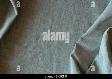 Abstract crumpled linen fabric texture background. Natural pale green color dyed linen organic eco textiles canvas background. Top view Stock Photo