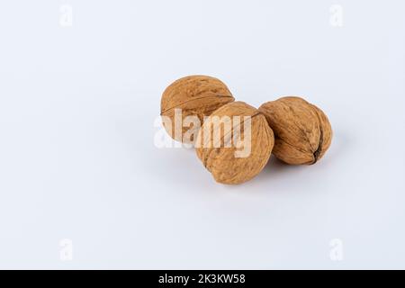 Close up of three walnuts isolated against white background Stock Photo