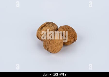Close up of three walnuts isolated against white background Stock Photo