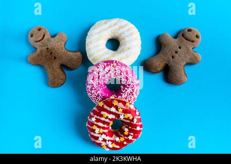 Donut with hazelnuts on blue background, close up Stock Photo