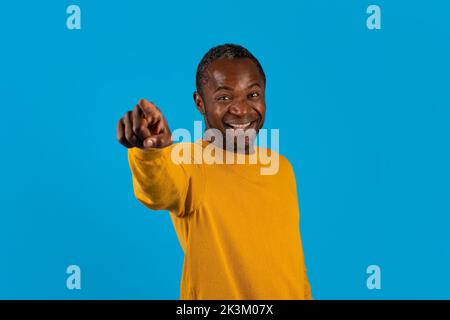 Positive black man pointing at camera and smiling Stock Photo