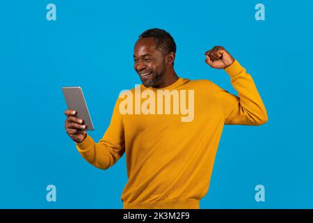 Emotional black man using digital tablet and gesturing Stock Photo
