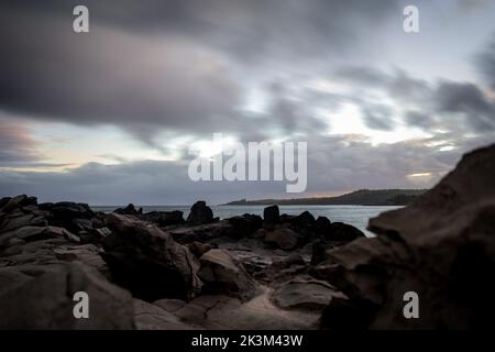 A beautiful shot of the sun rising over an autumn forest with colorful ...