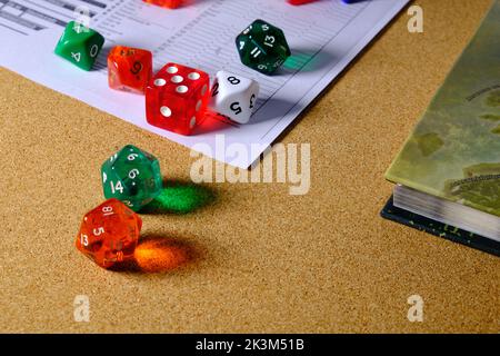 Game of dice to play role-playing of different colors on a table. Stock Photo