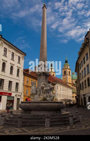 Ljubljana,Slovenia - Sept 3 2022.Robba Fountain in Town Square or Mestni Trg in Ljubljana. Called Robbov Vodnjak in Slovenian, Cathedral in background Stock Photo