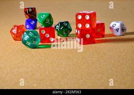 Several different colored role-playing game dice on a table. Stock Photo