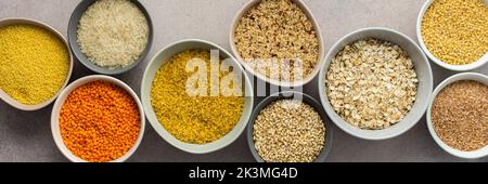 Various grain cereals in bowls banner, top view Stock Photo