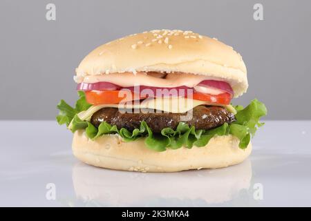 CRISPY CHEESY CHICKEN PATTY BURGER ON WHITE background Stock Photo
