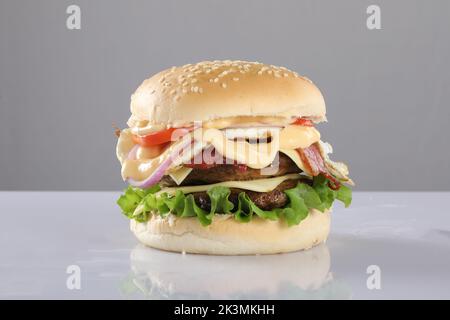 CRISPY CHEESY CHICKEN PATTY BURGER ON WHITE background Stock Photo